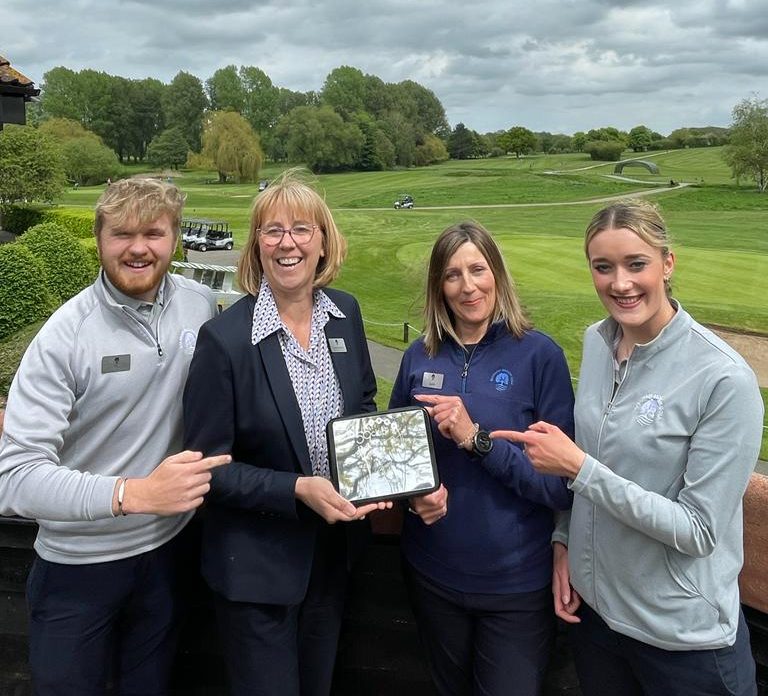 The golf team at Barnham Broom celebrate after being named the top golf resort in the East of England