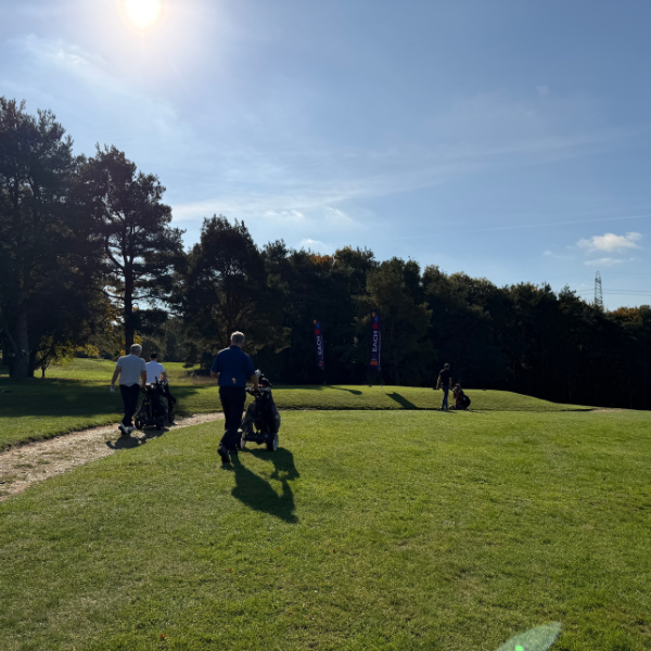 golfers walking on charity golf day